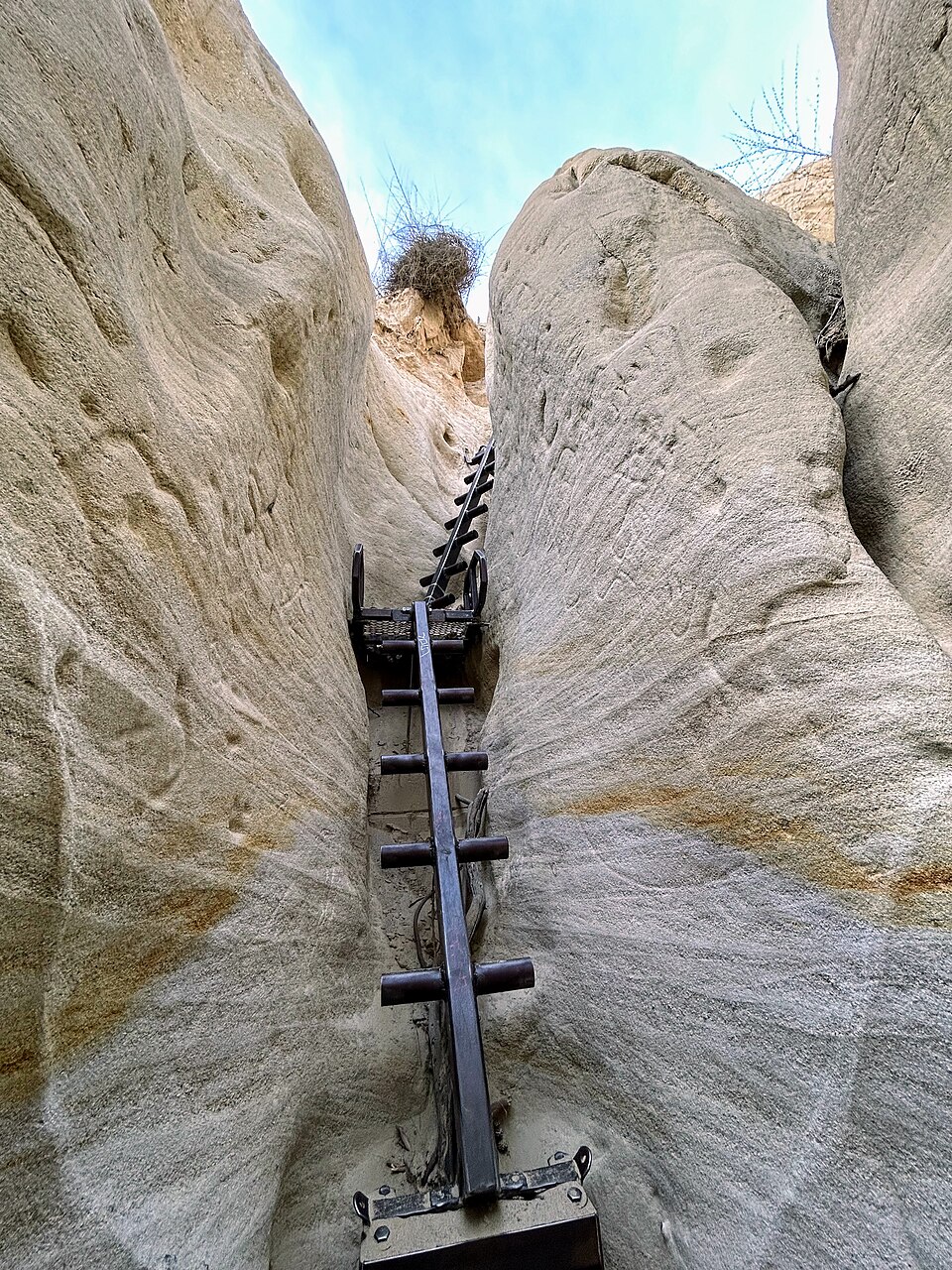 Narrow sandstone walls and climbing ladder at the Annie's Canyon exit